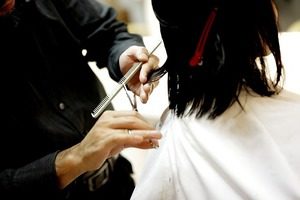 Hairdresser cutting a woman's hair