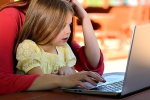 Mother and young daughter on a laptop